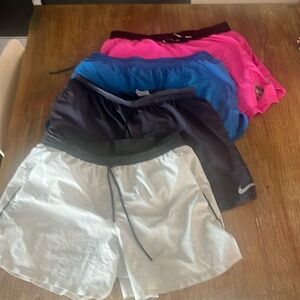 Lot of 4 Nike line running shorts. All size large. 3-5 inch inseams.